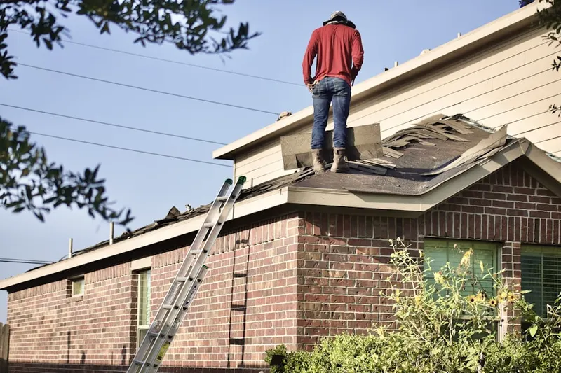Professional roofer working on a residential roof in Hygiene